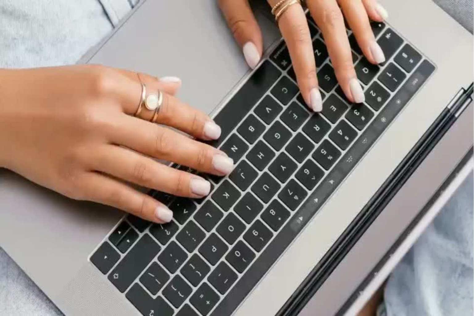 Person typing on a laptop, writing content