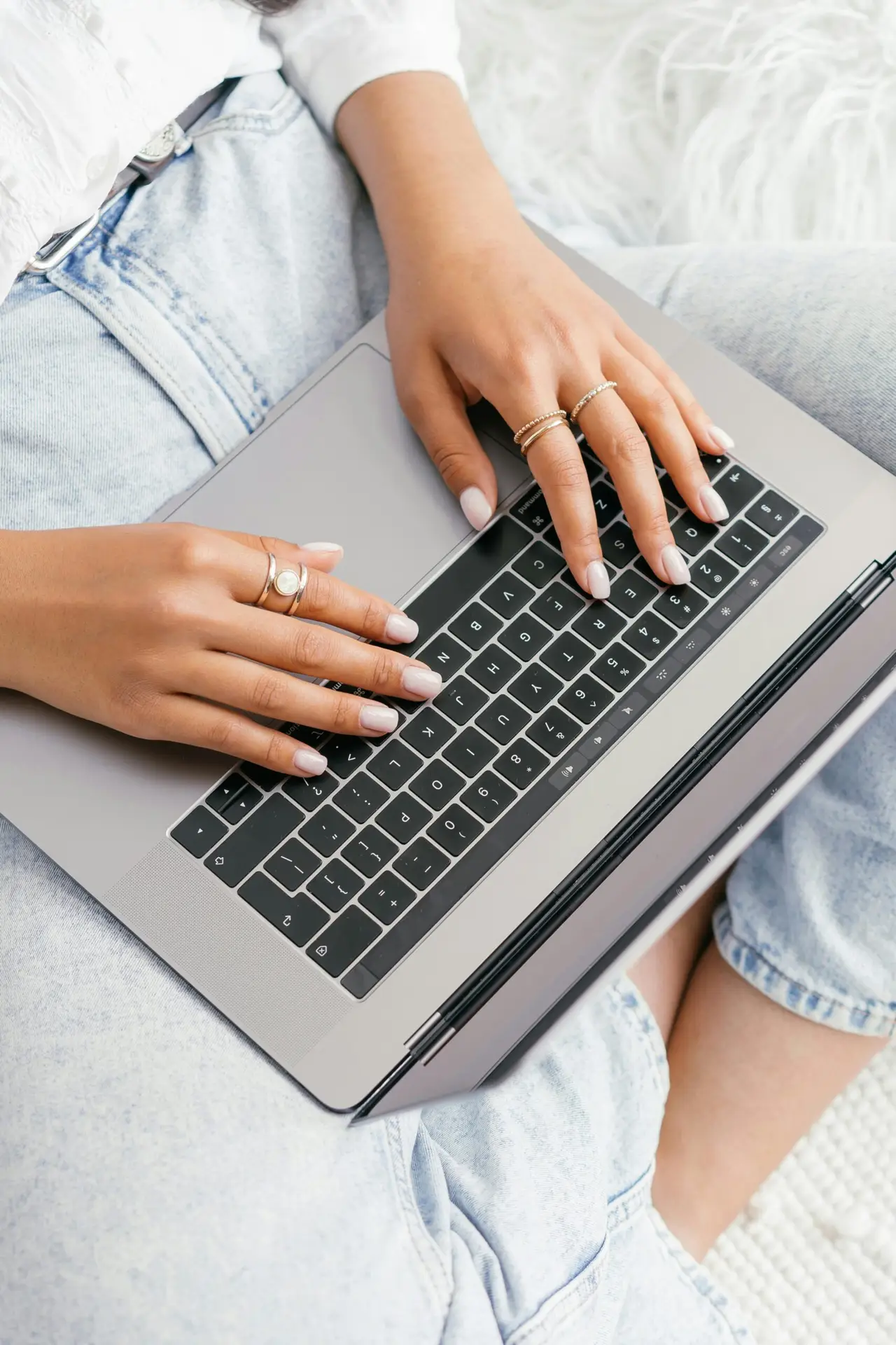 Person typing on a laptop, writing content