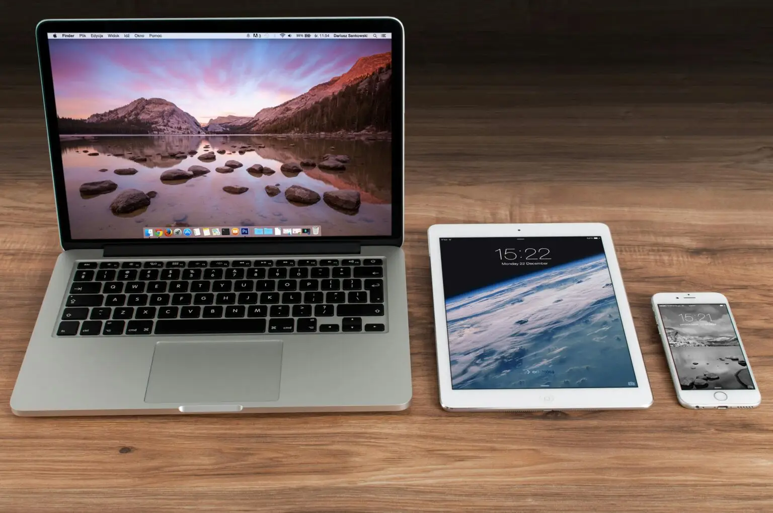 Website mockup shown across laptop, tablet, and phone screens
